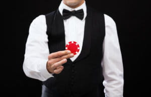 Live Dealer Casino Male Dealer holding casino chip