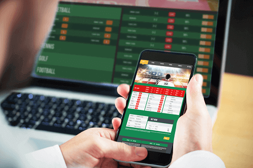 sports betting platform on phone and laptop
